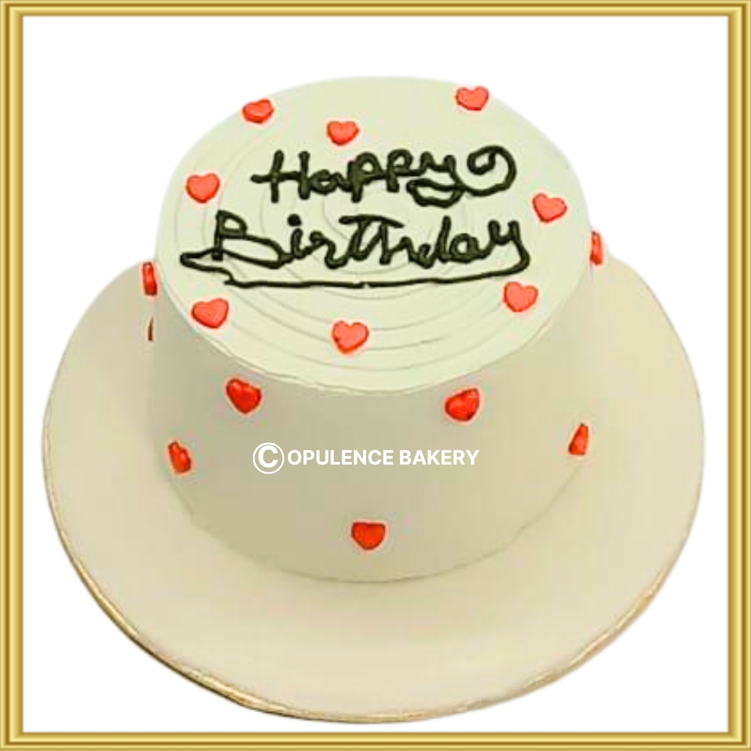Custom minimalist white birthday cake with red hearts in Lahore by Opulence Bakery.