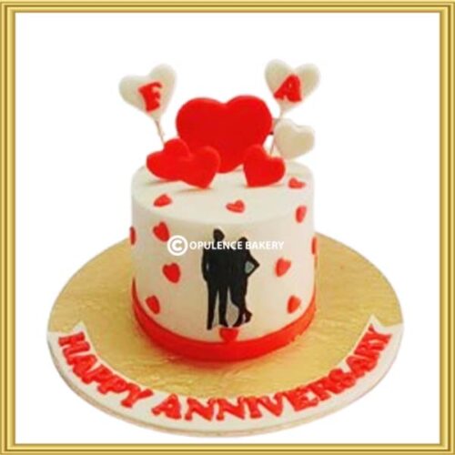 Custom romantic heart anniversary cake in Lahore featuring couple silhouette and red heart toppers by Opulence Bakery.