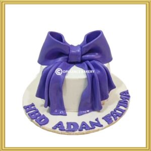 Royal purple bow theme birthday cake in Lahore by Opulence Bakery.