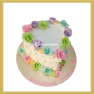 Heart shaped floral anniversary cake with pastel roses in Lahore by Opulence Bakery.
