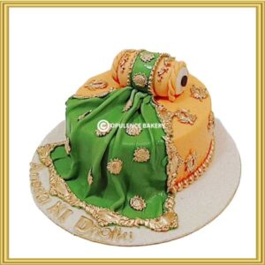 Customized dholki theme wedding cake with 3D dholak topper in Lahore by Opulence Bakery.