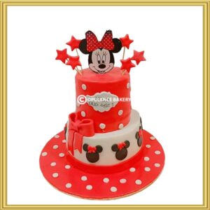 Custom 2 tier Minnie Mouse 1st birthday cake with red polka dots and star toppers in Lahore