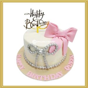 Custom pink bow birthday cake with silver pearls in Lahore by Opulence Bakery.