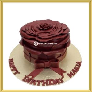 Hand-sculpted fondant maroon giant rose birthday cake in Lahore by Opulence Bakery.