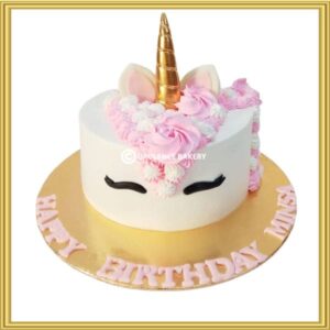 Custom magical unicorn birthday cake with gold horn and pink piping mane in Lahore