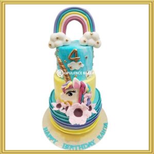 Unicorn rainbow 3 tier birthday cake in Lahore with gold horn and cloud toppers