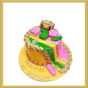 Traditional Mehndi Dholki theme cake in Lahore with gold lace, dholak, and paan toppers