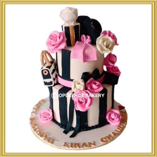 2-tier luxury fashion theme fondant cake with pink roses and handbag in Lahore by Opulence Bakery
