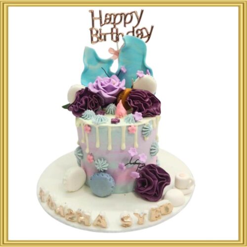 Pastel purple and teal drip birthday cake in Lahore with sugar roses, macarons, and rice paper sails